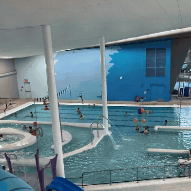 Families enjoying themselves in an indoor pool.