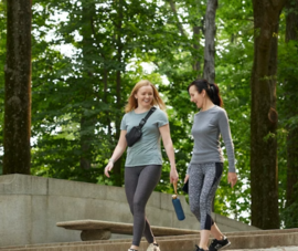 Two people walk at Roosevelt Island