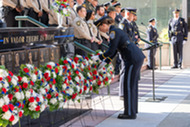 Honor Guard placing a rose at a wreath at Arlington's National Peace Officers Memorial Ceremony