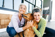 Two women with a dog.