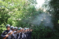 Seven police officers performing the 21 gun salute