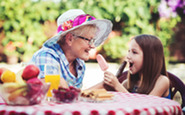 A senior woman and a young girl eating ice cream.