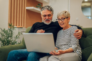 A man and a woman looking at a computer.