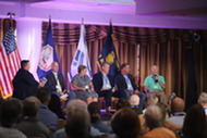 Panelists sit on stage at ACPD Remembers