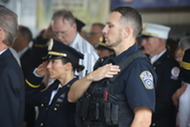 ACPD officers salute and place a hand over their heart during the national anthem at the 9/11 Ceremony at Station 5.