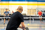 Adult men playing pickleball
