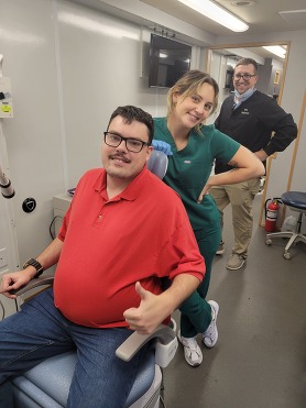 Picture of man on dental bus waiting to get dental work