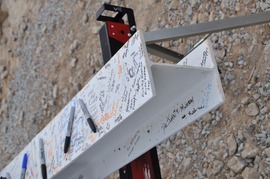 A structural beam to be placed in the new West Area Elementary, signed by students, staff, school and county leaders