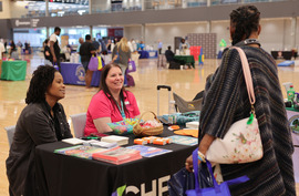 Staff speaks with an attendee at the 2024 Regional Recovery Day 