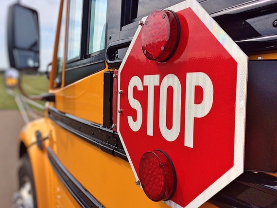 The exterior of a school bus and its stop arm