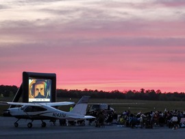 People watch a movie on an outdoor screen at the Chesterfield County Airport