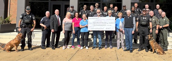 Dick Strauss and family present a check for $50,000 to the Virginia Police K-9 Association