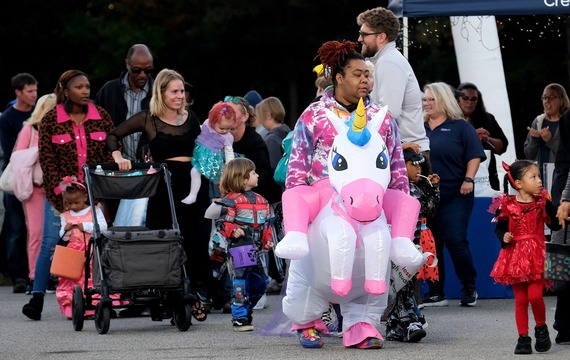 Parents and children in costumes file through to get candy at Chesterfield's Trunk or Treat event
