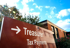 A sign directs residents to the Treasurer's Office to make tax payments