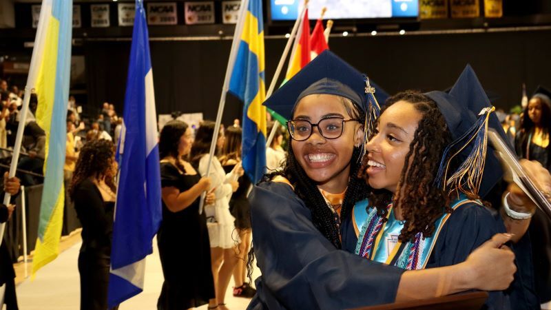 Graduating seniors embrace at Meadowbrook High School's 2024 commencement ceremony