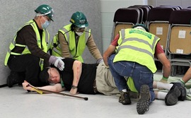 Participants tend to an injured man during a Community Emergency Response Team class