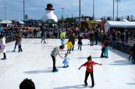 Adults and children skate on a synthetic ice rink at Chesterfield's Snowball Festival