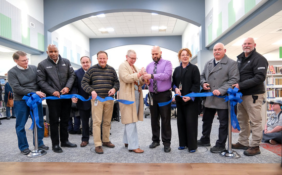 Board of Supervisors members and county staff cut a ribbon to mark the reopening of LaPrade Library