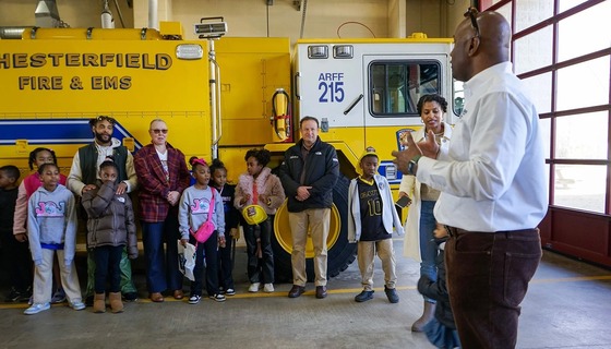 Board members and families next to a firetruck