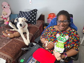 Pine Forest Resident with therapy dog on her bed