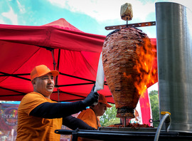 A vendor prepares to carve meat at Chesterfield's Latino Farmers Market