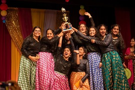 Dancers celebrate with a trophy after winning a competition at the annual Taste of India festival