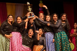 Dancers celebrate with a trophy after winning a competition at the annual Taste of India festival