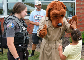 McGruff gives a child a high-five at a National Night Out event in Chesterfield