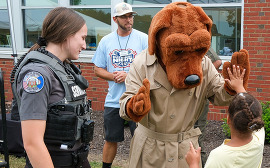 McGruff gives a child a high-five at a National Night Out event in Chesterfield
