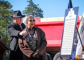 Nancy Ross, president of the Concerned Citizens of Ettrick, reads the history of Dupuy Elementary School at the groundbreaking for Ettrick Landing