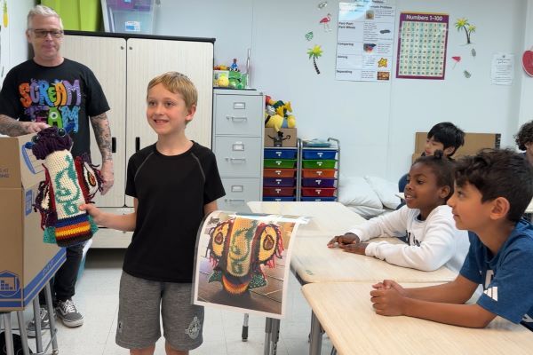 A Swift Creek Elementary student shows off his monster drawing