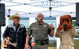 Sherriff, performer, McGruff the Crime Dog on stage at an NNO event