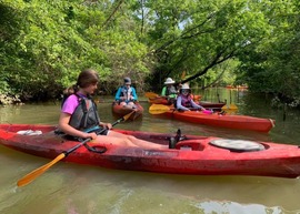 Group of people kayaking on calm water