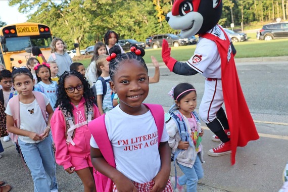 Cheered on by Nutzy, students head into the building for the first day of school 