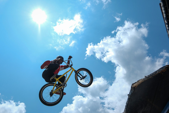 A BMX rider performs acrobatic aerial stunts at Chesterfield Outdoor Fest