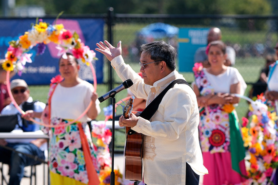 A musician sings and plays guitar during the Community Cup at River City Sportsplex
