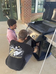Student and mentor working at grill