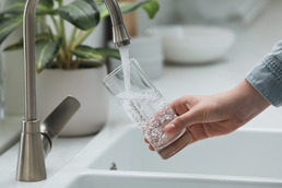 Tap water poured into drinking glass