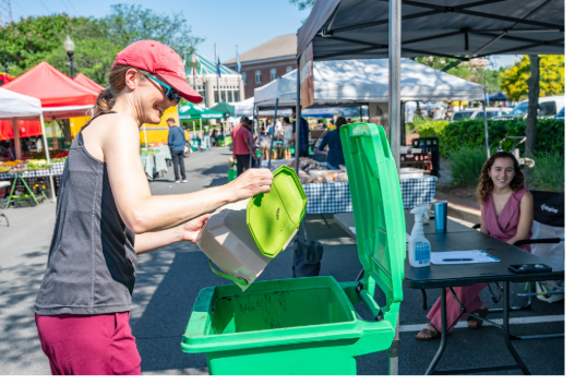 A community member composting their food at the Herndon farmer's market