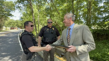 DEQ's John Giese presents the official commendation to Henrico County Fire Marshals