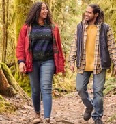 Young African American man and woman walking in the woods