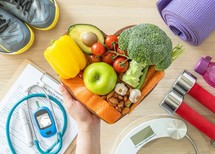 Group of healthy foods and exercise equipment