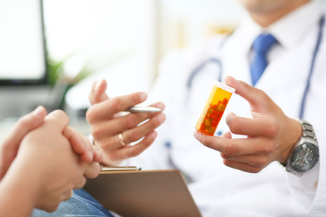 Doctor giving prescription to patient