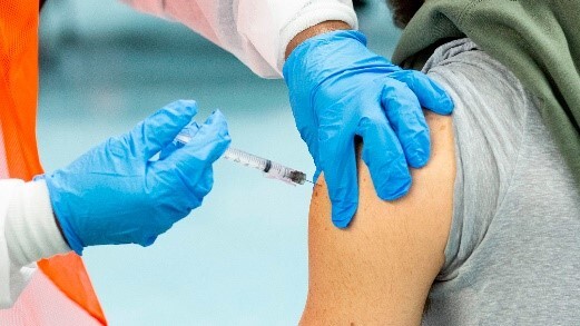 Doctor giving a patient a vaccination