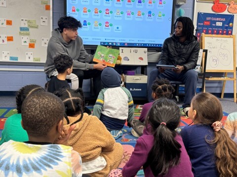 Prince William’s Potomac High School varsity basketball players read to elementary students.