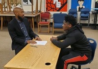 A student and teacher participate in a mock interview.