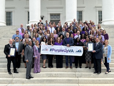 A large group of people wearing purple to celebrate Purple Up day