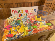 A summer themed book display that says Read, Relax, Repeat!