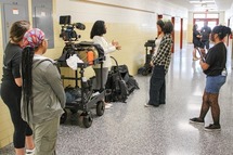 Students filming a short film in a school hallway