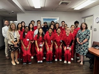 A group of students in red scrubs at the Bradley Free Clinic